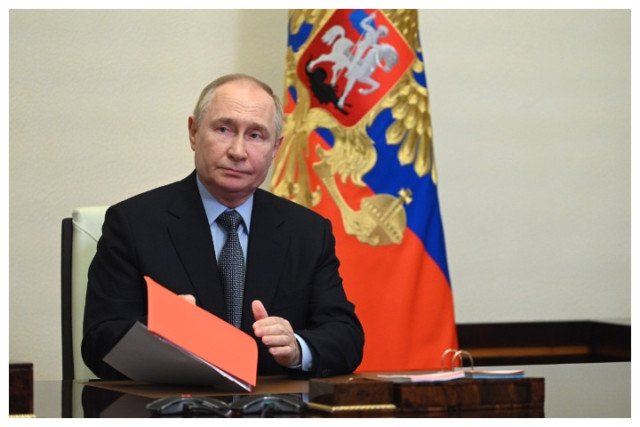 Russian President Vladimir Putin chairs a meeting with members of the Security Council